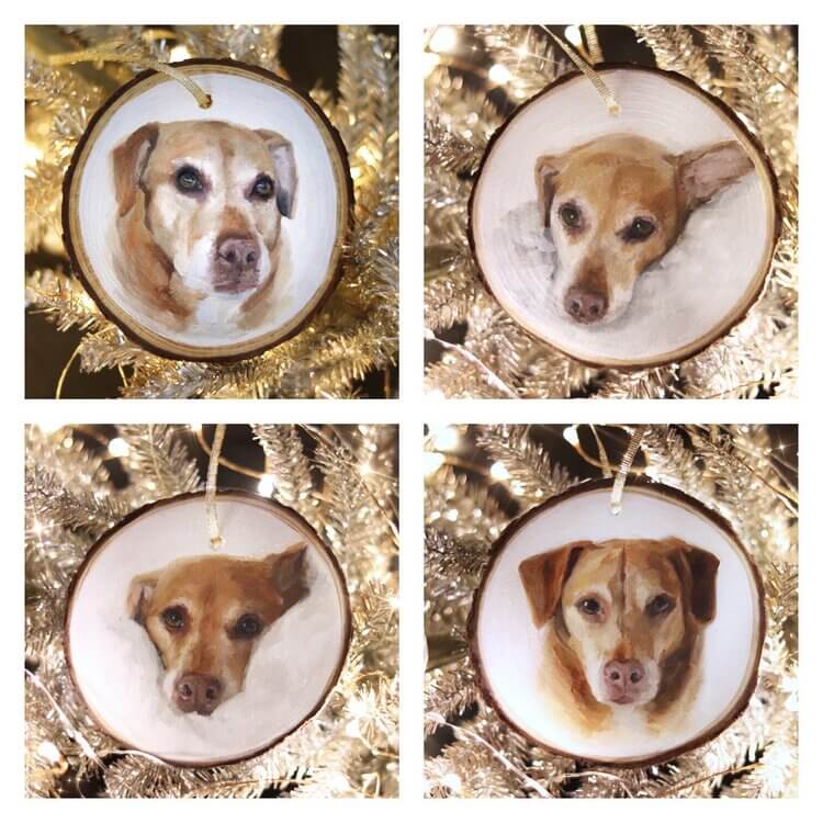 round wood ornaments with painting of dog face hangs on shiny silver tinsel tree