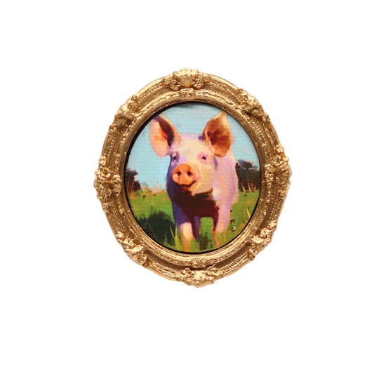 Gold-framed picture of a pig on a white background
