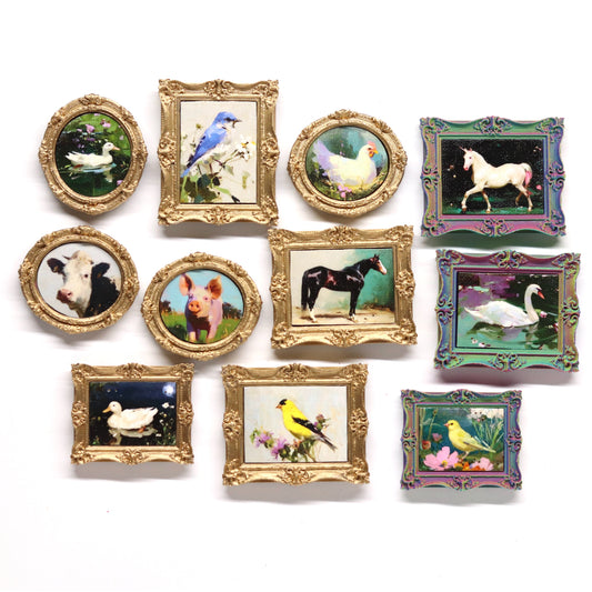 Collection of small framed pictures with animal illustrations on a white background